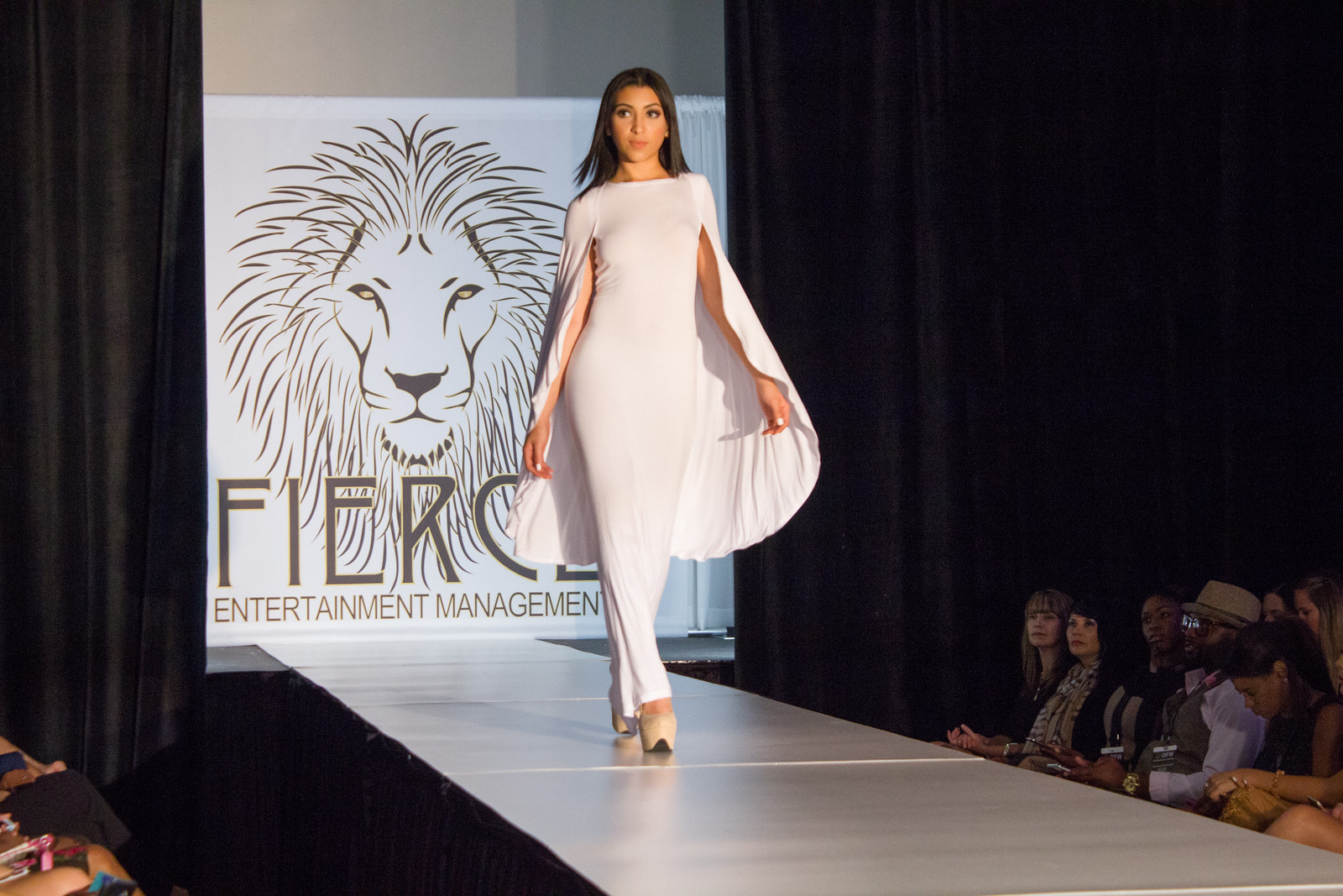 Model in white on the Orlando International Fashion Week runway
